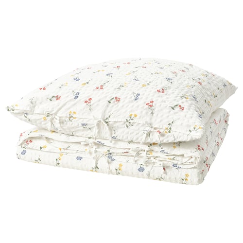 The PILDVÄRGMAL duvet set, white with colourful floral prints, a soft cotton-viscose blend and a seersucker texture.