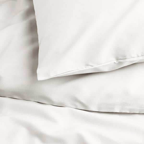 Smooth white bedding, likely made of high-quality, eco-friendly fabric. Shows clean lines and fine sheen.