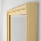 High-quality beveled edge mirror in sleek pine frame, mounted vertically for elegant decor.