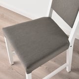 Modern chair with white frame, grey cushion. Cushion securely attached, appears well-made.