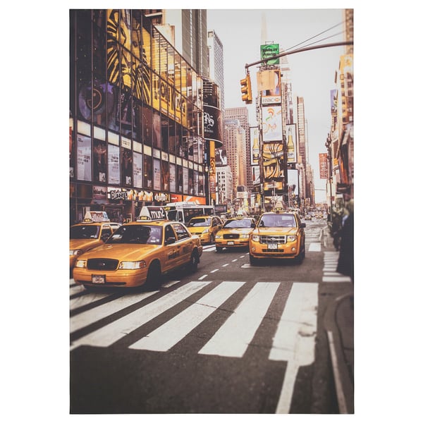Busy urban street with yellow taxis, tall buildings, and bright signs.