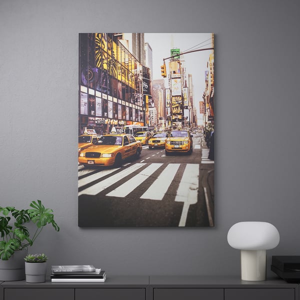 Framed city photo with taxis, buildings, and decor below.