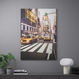 Framed city photo with taxis, buildings, and decor below.