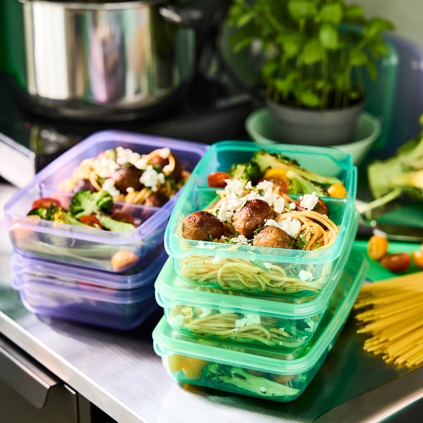 Colorful, stackable food containers with compartments for sandwiches and sides, ideal for packing meals for kids.