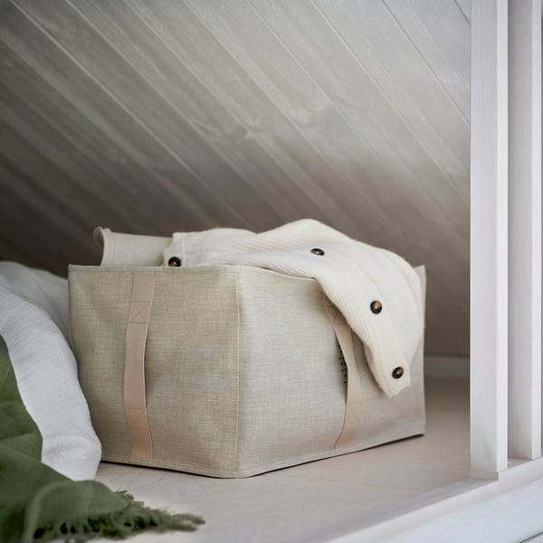 Beige fabric storage box with handles, part of PURRPINGLA series, organizes clothes & bedding, fits pax wardrobes, with ventilation.