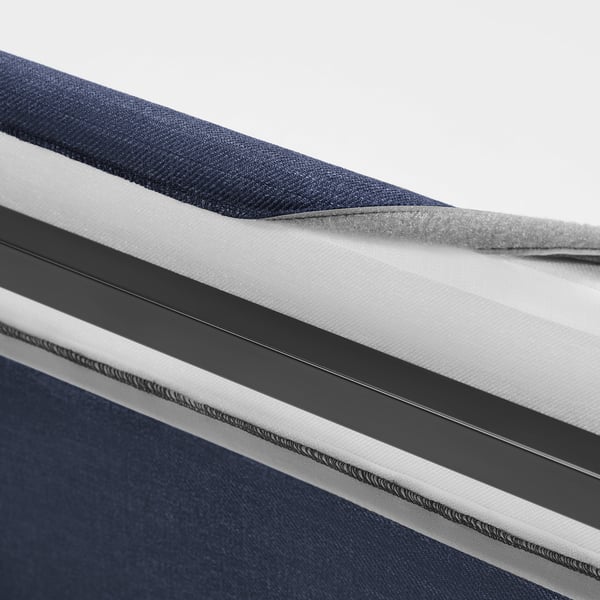 Close-up of RAMNEFJÄLL bed cover with smooth fabric and clean lines, showing removable design for easy washing.