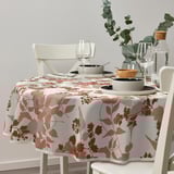 Recycled polyester tablecloth with leafy pattern on earthy-toned table, surrounded by white chairs, decorated with greenery, wine glasses, and plates.