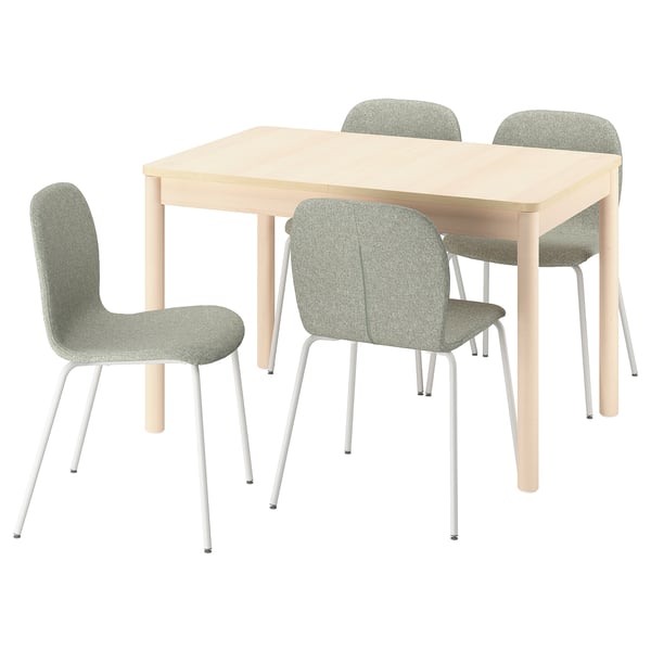 A light wooden dining table with four green upholstered chairs, designed for easy extension and comfortable seating.