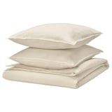 Beige bedding set, including duvet and pillows, made from soft cotton and linen, featuring a casual, wrinkle-chic design.