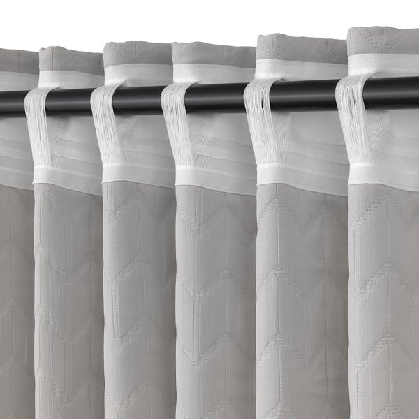 Curtain panel with rod loops, designed to block drafts and insulate windows, featuring pleated fabric for light control and privacy.