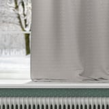 A curtain with textured pattern covers a window, its fabric blocks drafts and insulates heat, offering energy efficiency and privacy.