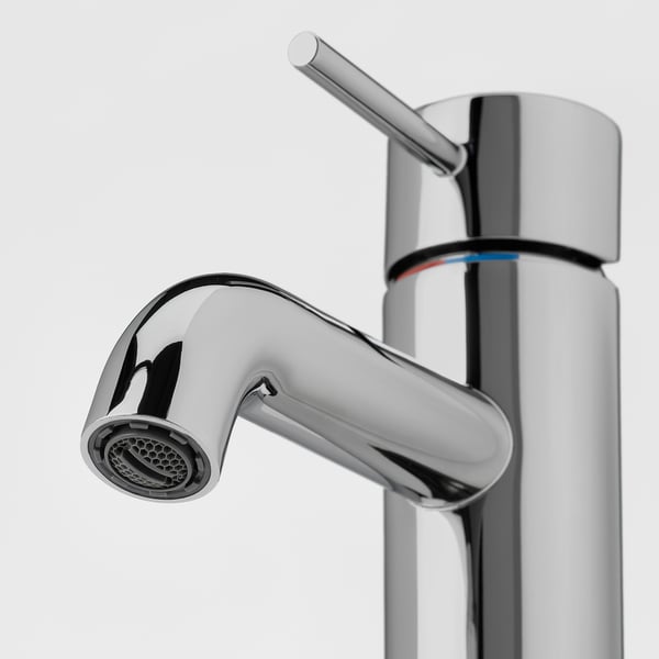 Polished chrome tap with sleek handle and shower head, featuring high-quality finish and modern design.