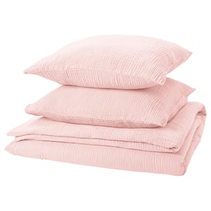 A neatly stacked set of pink SCHERSMIN bed linens, featuring a duvet cover and pillowcases in soft muslin cotton.