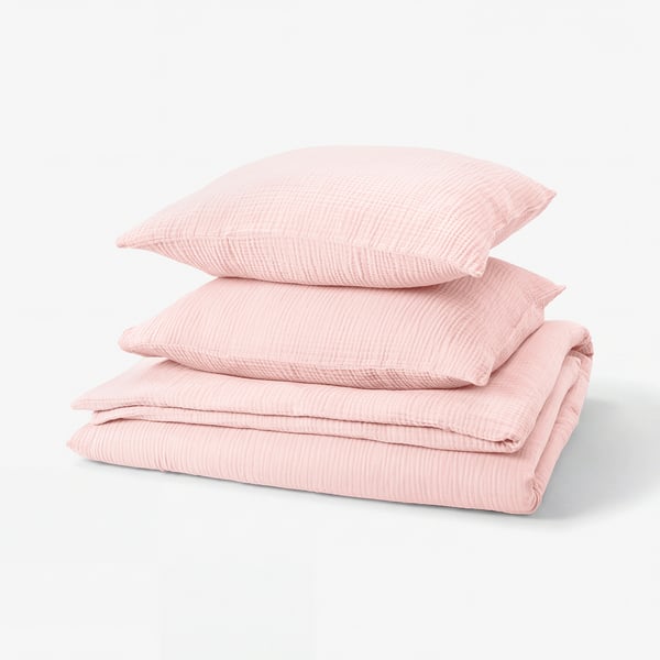 Displays a pink SCHERSMIN bedding set, featuring a duvet cover and two pillowcases in soft organic cotton with a textured, wavy design.