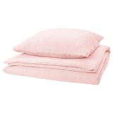 Light pink bedding set with textured design, folded neatly.