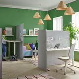 T-shaped workspace with 3 room dividers, light wood furniture, and green plant, lit by woven lamps.