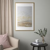 Modern living room decor: SILVERHÖJDEN frames, grey curtain chair, side table with book, mug, and eucalyptus.