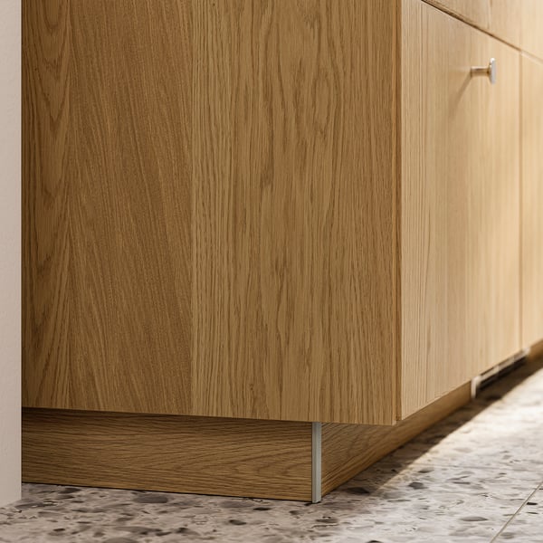 Light brown wooden kitchen cabinet plinth.