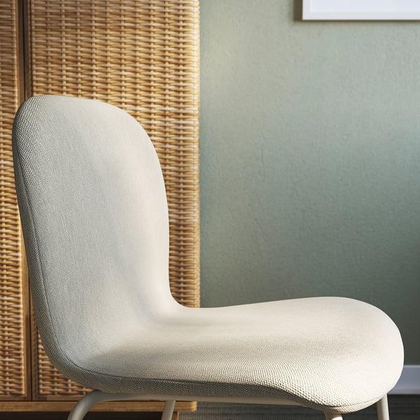 Modern upholstered chair, light grey, smooth texture, clean lines, set against woven backdrop.