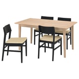 Modern dining set with light wooden table and four black chairs, featuring woven seats.
