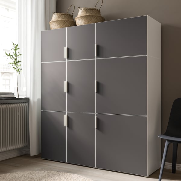 Modern grey wardrobe with six doors, storing clothes and protecting them from dust. Two woven baskets on top.