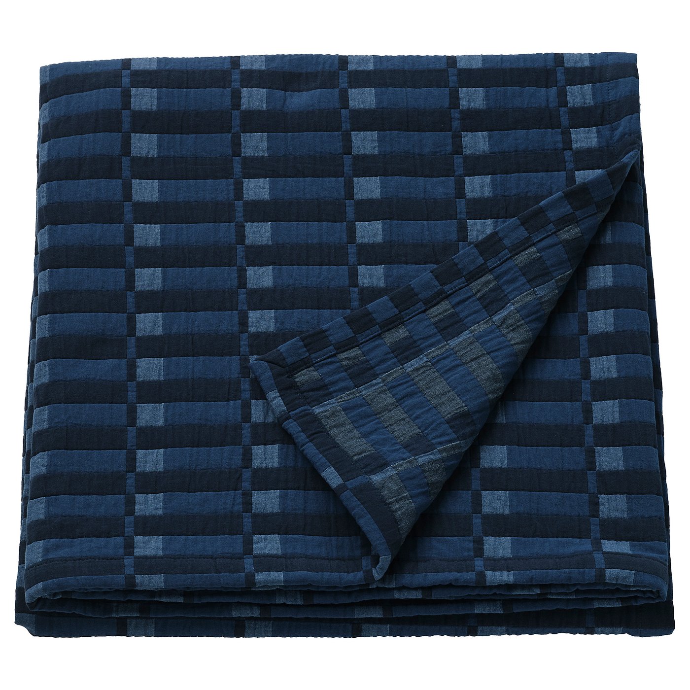A folded SKOGSKOVALL dark blue plaid blanket with a cotton material.