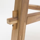 A sturdy wooden table leg joint, finely crafted with durable acacia wood, showcasing precise joinery.