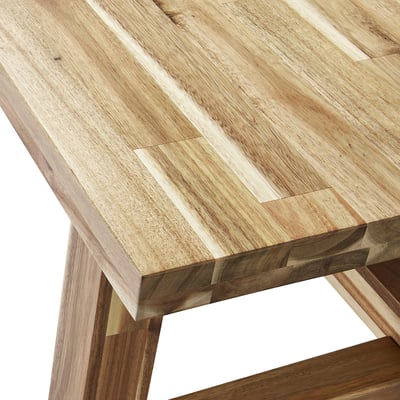 Close-up of a solid acacia table showing its rich grain and durable finish.