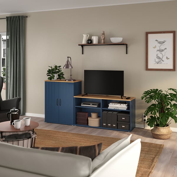 Blue SKRUVBY tv stand in modern living room with wood, storage & plants.