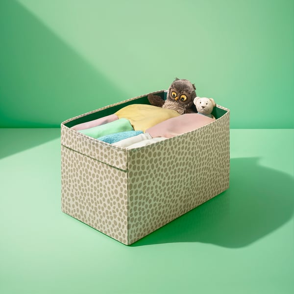 Leopard-print storage box with stuffed animals and folded clothes, designed for easy access and organization.