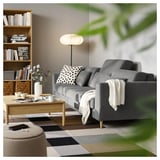 Modern living room with gray SLATORP sofa, polka dot pillows, wooden coffee table, bookshelf, and floor lamp.