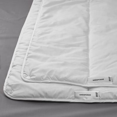 White cotton-polyester duvet with smooth texture, two-piece design, and brand labels.