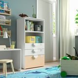 Childs room with white SMÅSTAD bookcase, wooden toy crate, blue rug, and stool.