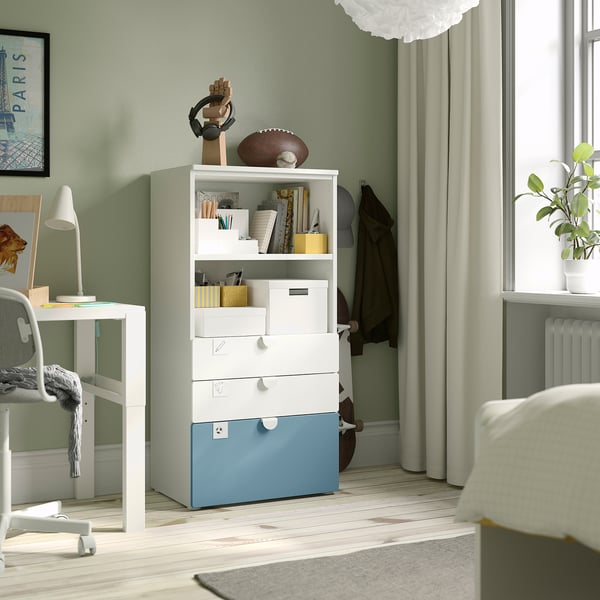 SMÅSTAD bookcase with blue accents, football, books, desk, and plant.