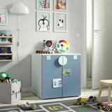 Childs room with blue SMÅSTAD cabinet, toys, books, clock.