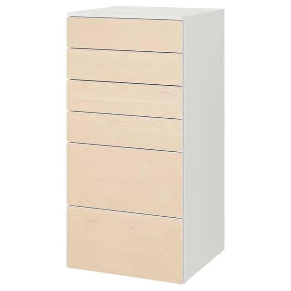 A white ikea SMÅSTAD chest with six light wooden drawers, designed for baby or childs clothes storage.