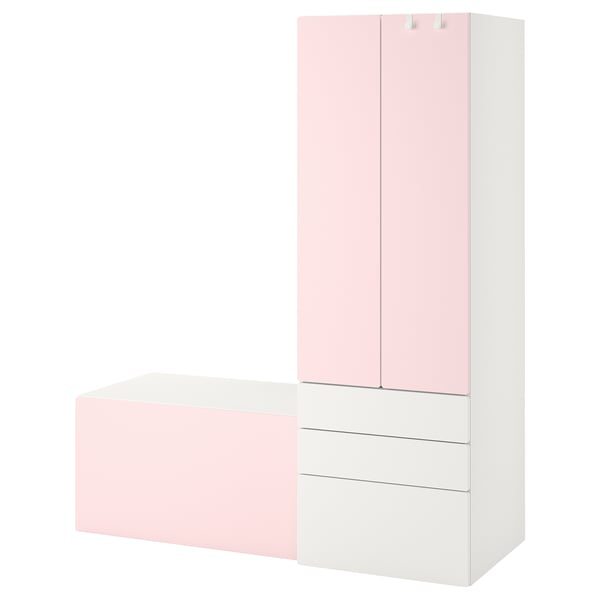 A white and pastel pink kids storage unit with cabinet, drawers, and a bench by SMÅSTAD.