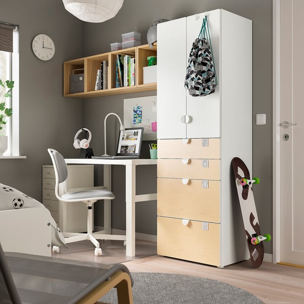 Modern kids room with SMÅSTAD white & natural wardrobe, desk, chair, skateboard, headphones, and shelf.