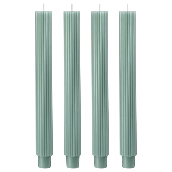 Four green fluted candles in a row.