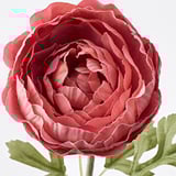 Vibrant red artificial flower with green leaves, crafted from recycled materials for durability and realism.