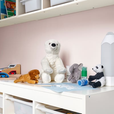 Childs desk with SNUTTIG bear, lion, elephant, panda, and art supplies.