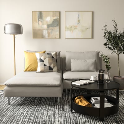 Modern living room: grey SÖDERHAMN sectional sofa, minimalist coffee table, floor lamp, and abstract art.