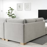 Light gray SÖRVALLEN sofa, modern minimalist design, large, with cushions, near plants and tv, in a minimalist room.