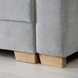 Modern sofa with clean lines. Light wood legs support cushioned seat. Quality upholstery in neutral fabric.