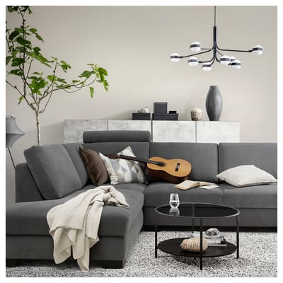 Modern living room with grey SÖRVALLEN sofa, coffee table, plant, and chandelier.