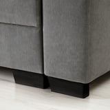 A modern sofas corner, upholstered in gray fabric, with sleek black wooden legs.