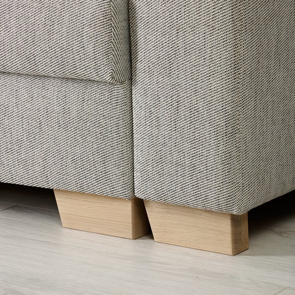 Sofa base detail: two wooden pieces with a light finish, seamlessly supporting sofas sleek, patterned fabric.