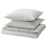 Three stacked gray and white striped pillows with zippered edges.