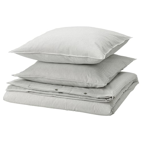 Three stacked grey and white striped pillows with zippered edges.