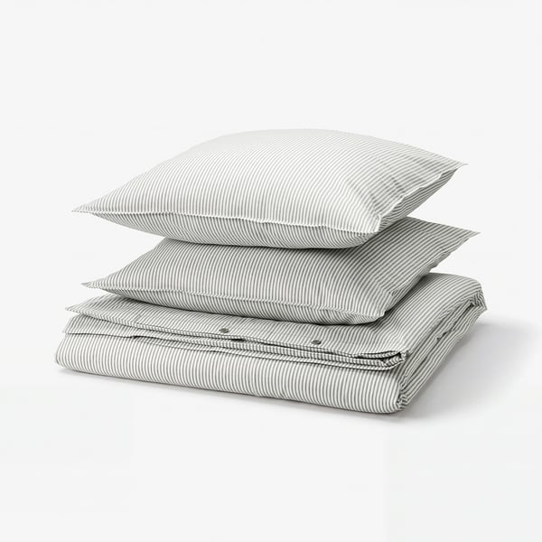 Stack of grey and white striped cotton bed linen, including duvet cover and pillows, neatly folded.